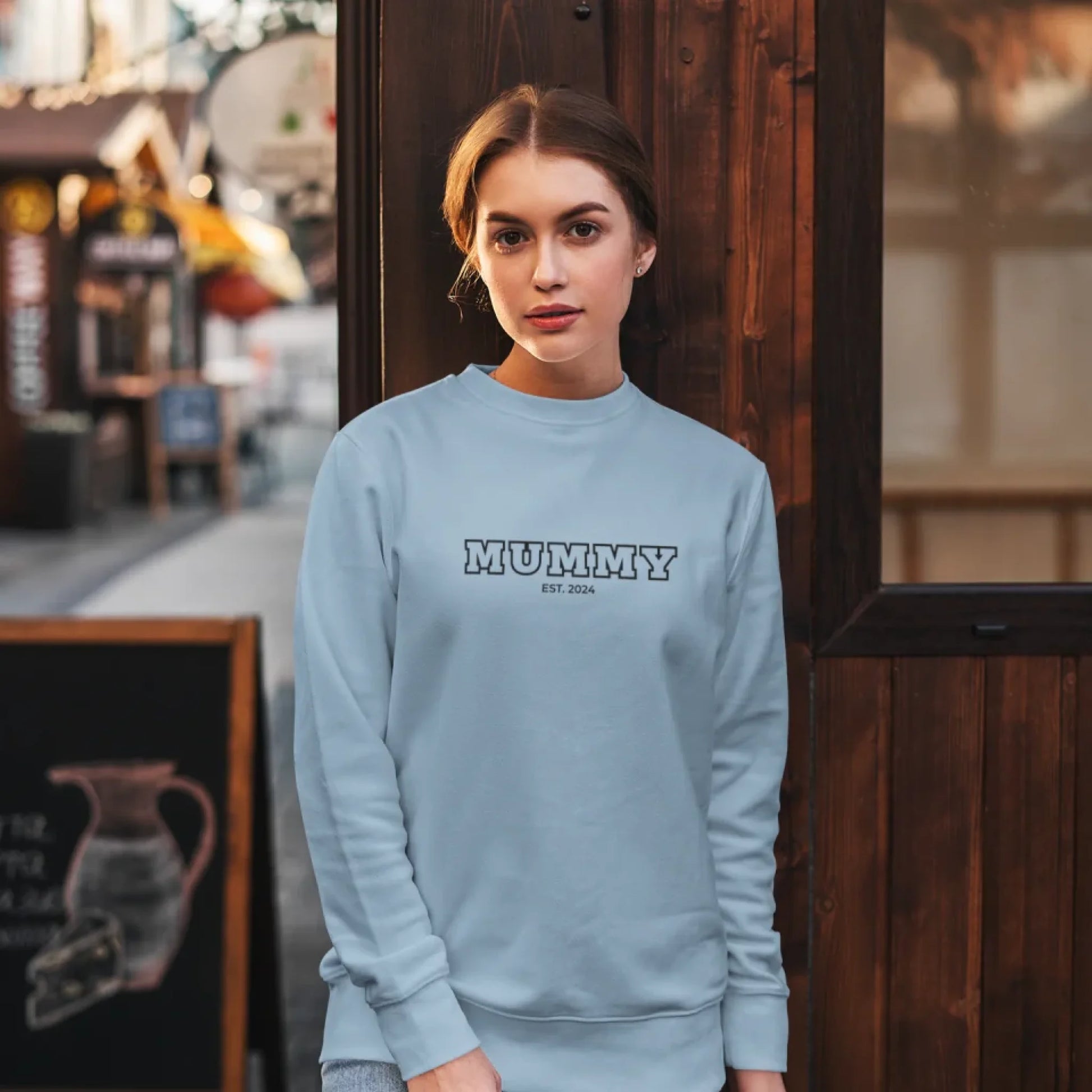 sweatshirt-mockup-featuring-a-woman-posing-against-a-wooden-wall-5293-el1